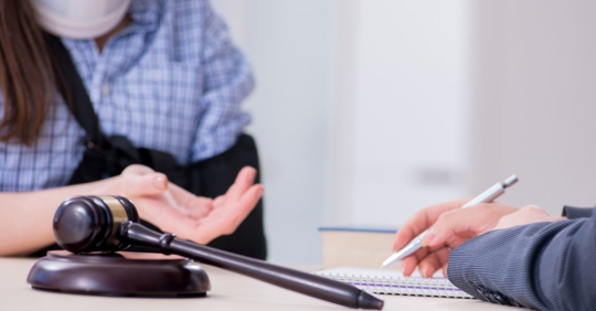 injured woman talking to a lawyer